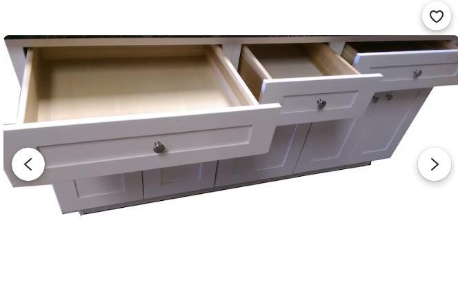 White kitchen cabinet with open drawers on a white background