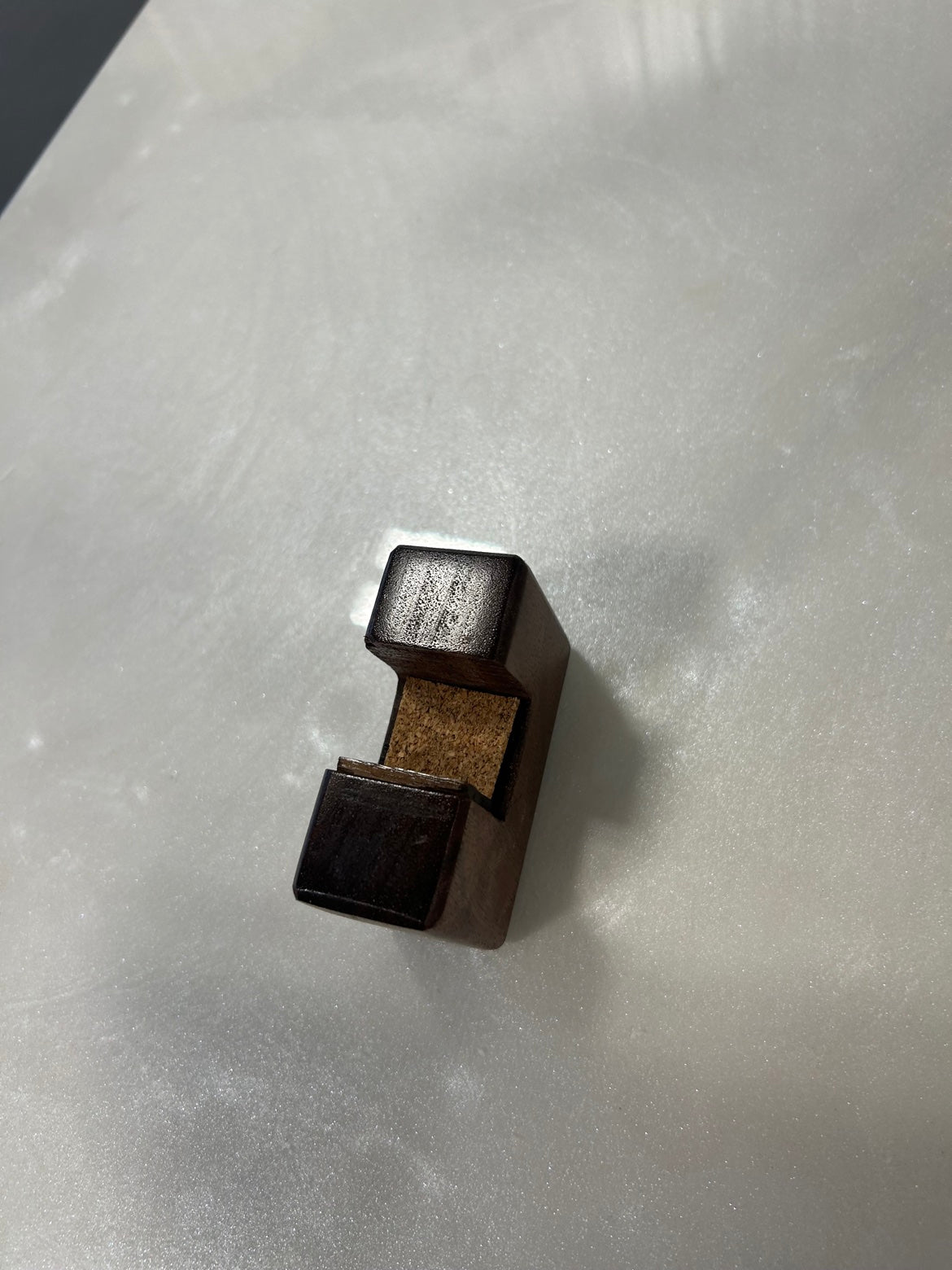 Close-up of the removable walnut foot