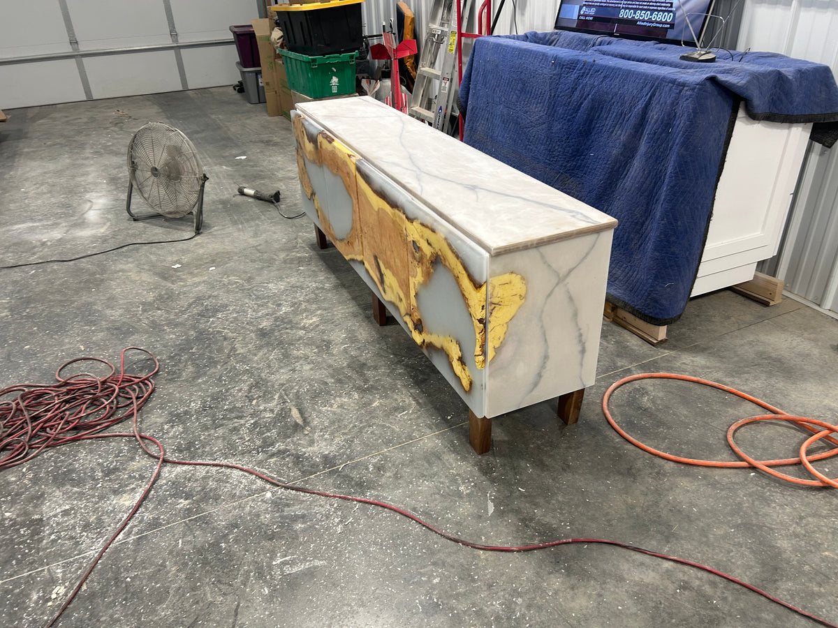 Floating media console showing gold resin inlay detail