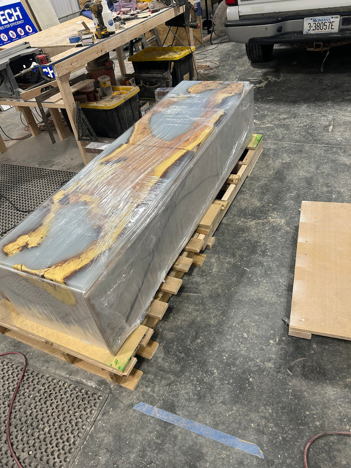 Media console wrapped and crated on a pallet for freight shipping