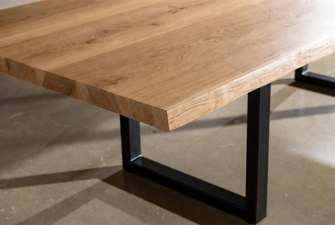 Wooden table with black metal legs on a concrete floor