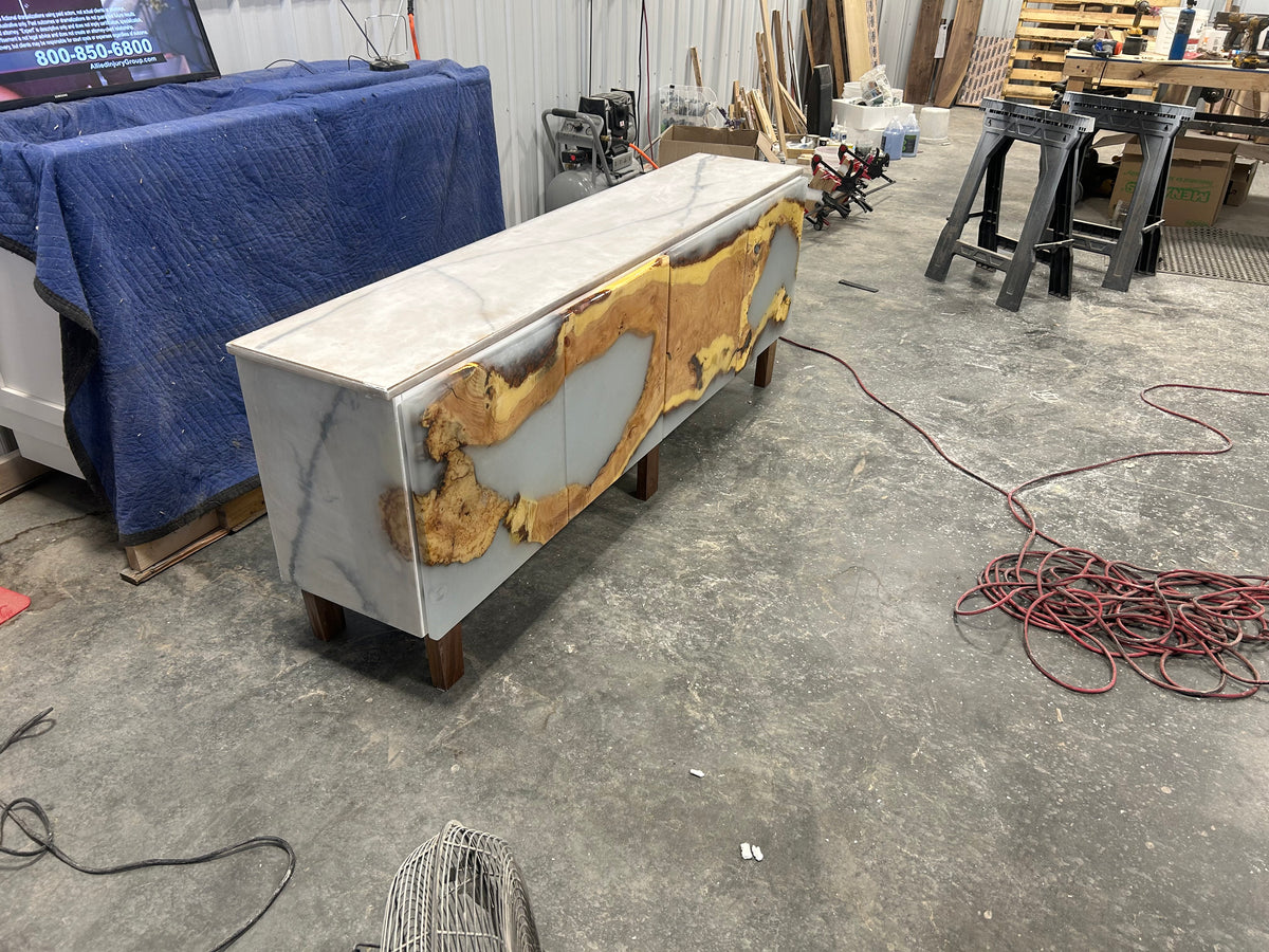 Live edge media console with gold resin accents in the workshop