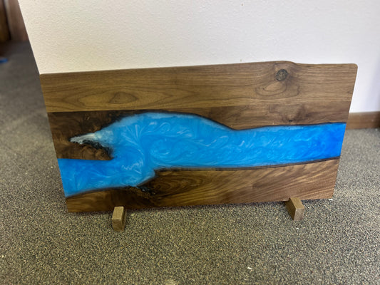 Wooden board with blue resin inlay on a carpeted floor