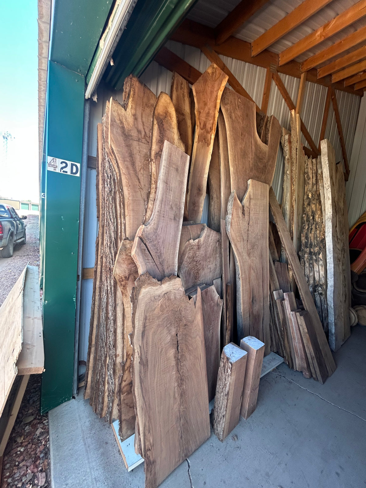 Raw black walnut slabs in the workshop before crafting the dining table