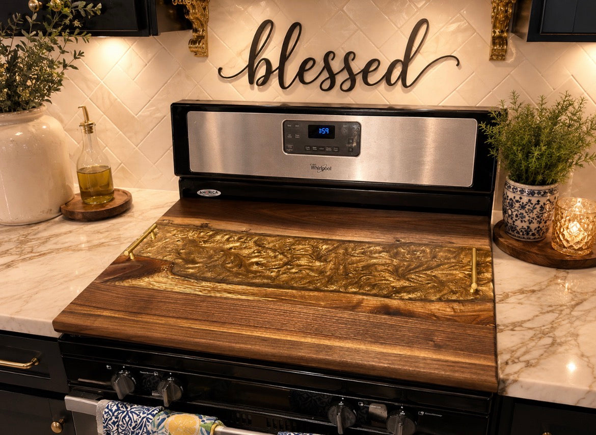Noodle board with amber gold epoxy on a stainless steel range