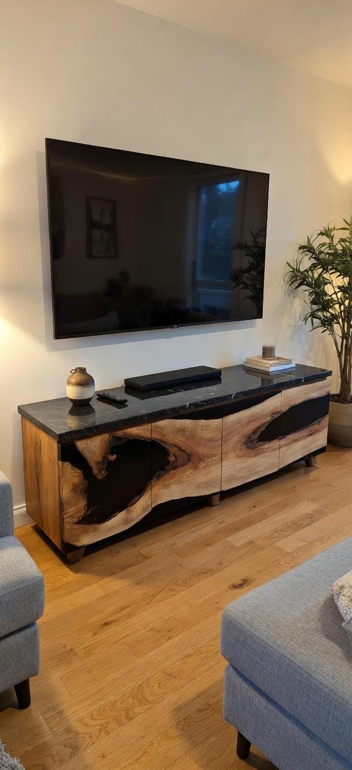 Modern living room with a large flat-screen TV mounted on the wall above a wooden console table.