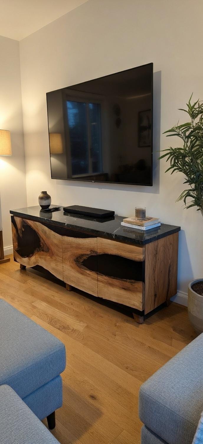 Living room with a television mounted on the wall above a wooden console table.