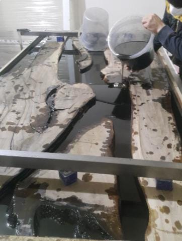 Glass table with water damage on a patterned floor