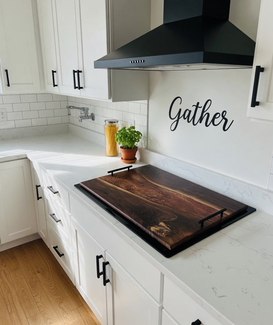 Walnut noodle board stove cover on a white range in a farmhouse kitchen