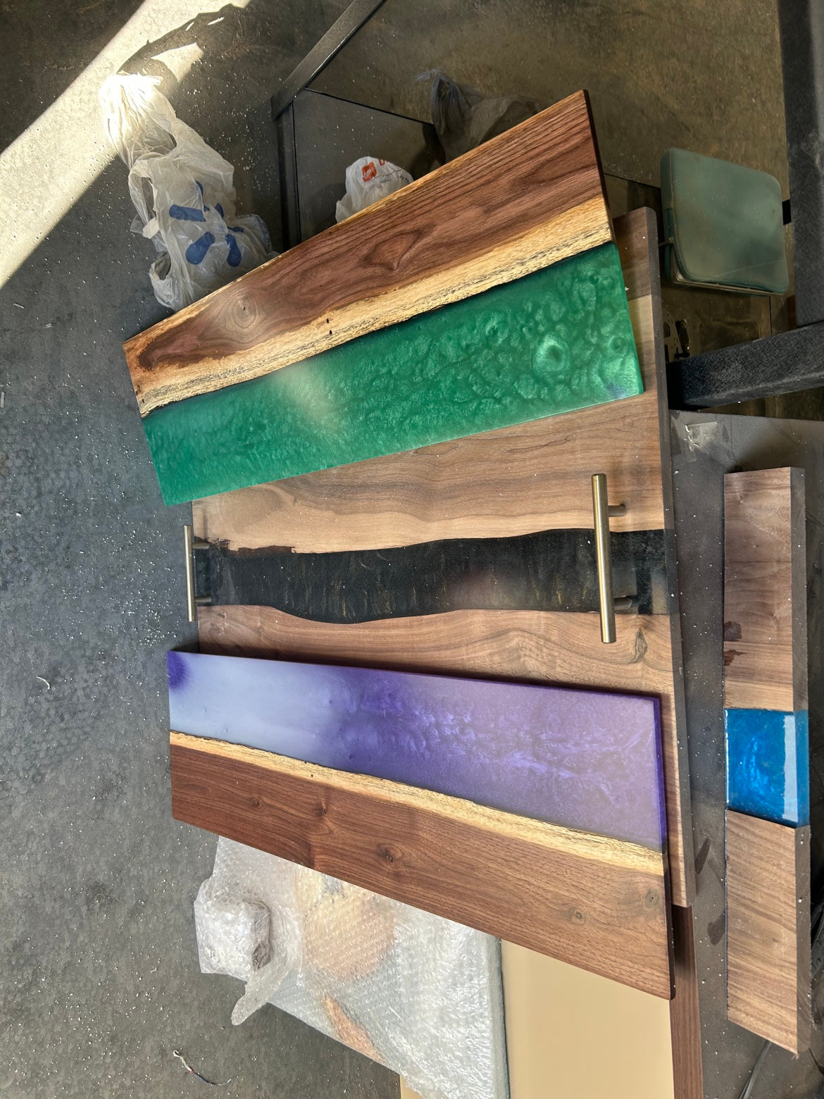Group of finished WoodNLUX walnut and epoxy boards