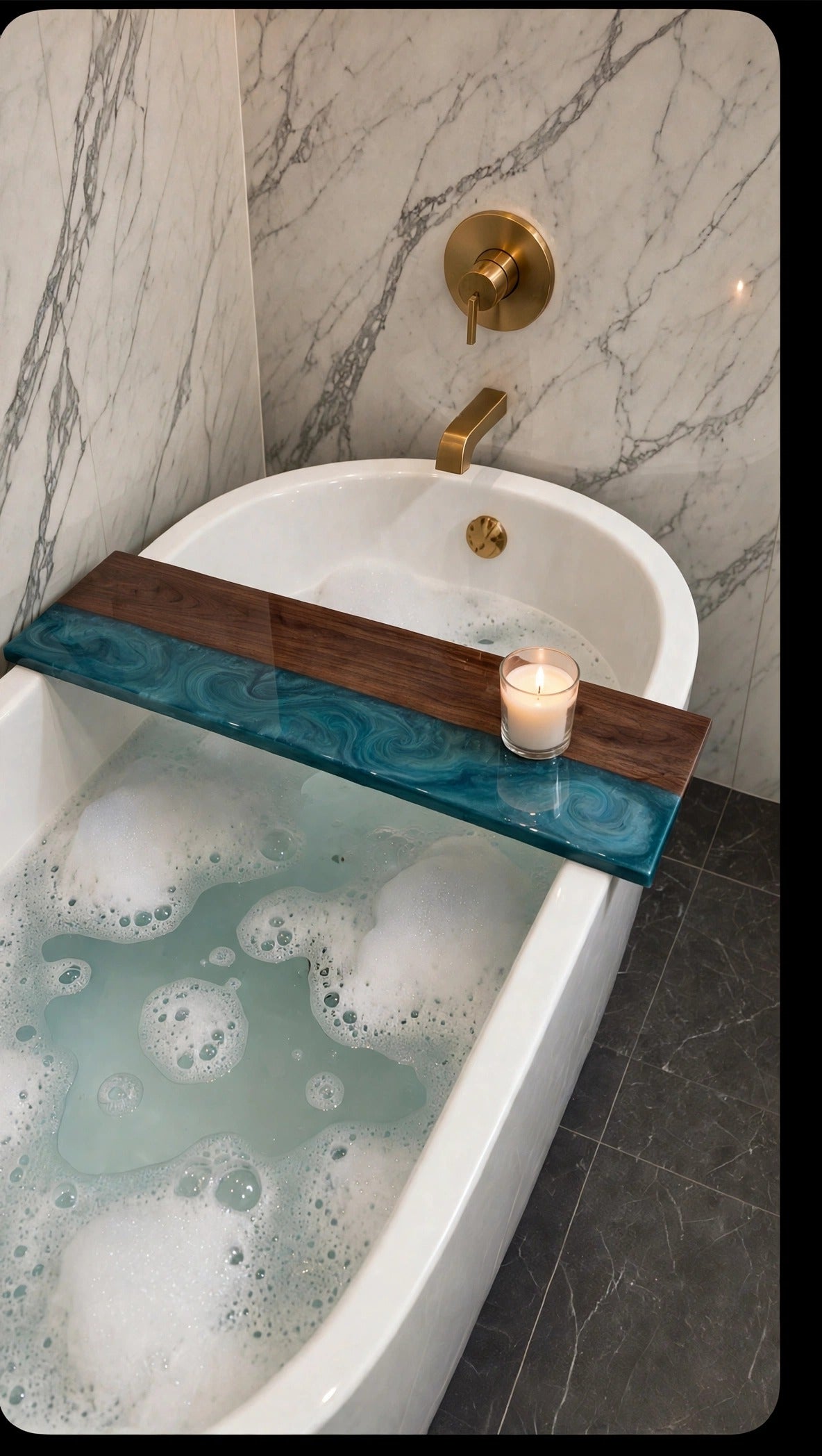 Walnut bath caddy with teal epoxy river on a freestanding tub with a candle
